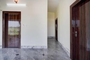 an empty hallway with two doors in a building at Hotel O Highway Kitchen in Bara Khera