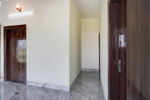 an empty room with a door and a hallway at Hotel O Highway Kitchen in Bara Khera