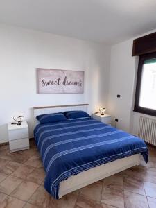 a bedroom with a bed with a blue comforter at Casa Mary in Domodossola