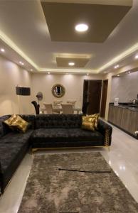a living room with a black couch and a table at horizon sky pyramids in Cairo
