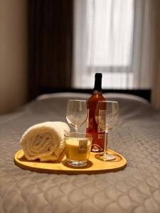 a tray with a bottle of wine and two glasses at The Gold Resident Airport Warszawa-Modlin in Nowy Dwór Mazowiecki