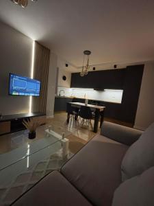 a living room with a couch and a table at The Gold Resident Airport Warszawa-Modlin in Nowy Dwór Mazowiecki
