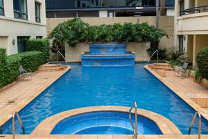 a swimming pool in the middle of a building at 1 Bedroom Apartment In the heart of Parramatta CBD in Sydney