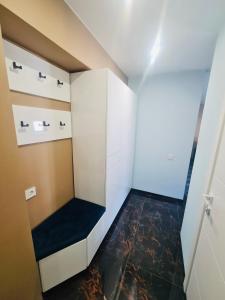 a small room with a black floor and white walls at G Apartments in Rēzekne