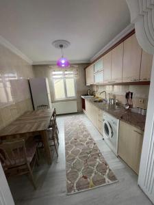a kitchen with a table and a sink and a dishwasher at PELİTLİ REZİDANS Otel in Trabzon