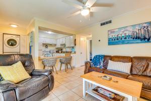 a living room with leather couches and a table at Cute Cocoa Beach Condo w/ Pool & Beach Access! in Cocoa Beach