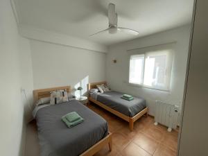 a bedroom with two beds and a window at Ca Ona in Chella