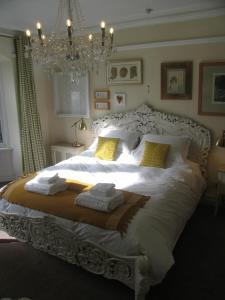 a bedroom with a large white bed with towels on it at Lindores Bed & Breakfast in Todmorden