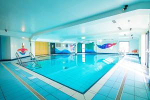 a large swimming pool with blue tiles on the floor at B17 SilverSands Escape in Lossiemouth