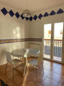 a dining room with a table and chairs at Ca Ona in Chella +12 photos