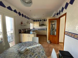 a kitchen with a table and a kitchen with blue accents at Ca Ona in Chella