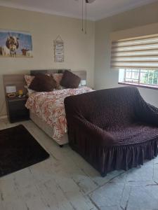 a bedroom with a bed and a window at Serene on 5 Cologne in Germiston