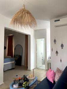 a living room with a couch and a table at Cozy Sousse Studio in Hammam Sousse