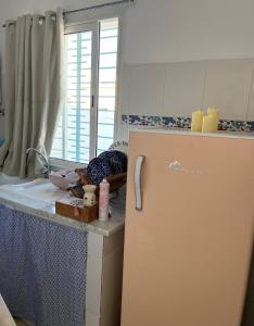 a kitchen with a refrigerator next to a counter at Cozy Sousse Studio in Hammam Sousse