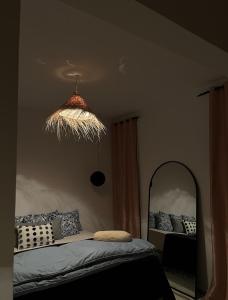 a bedroom with a bed and a large mirror at Cozy Sousse Studio in Hammam Sousse +7 photos