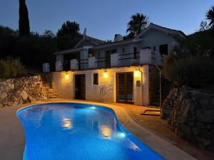 a house with a swimming pool in front of a house at Casa Olivo in Casarabonela