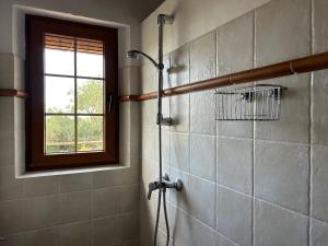 a shower in a bathroom with a window at Casa Olivo in Casarabonela +14 photos
