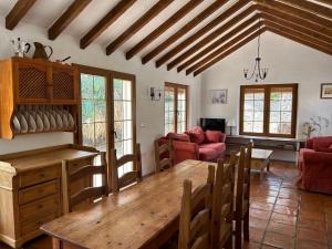 a living room with a wooden table and a couch at Casa Olivo in Casarabonela