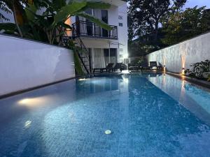 a swimming pool on the side of a building at Luvi’s Villa in Galle