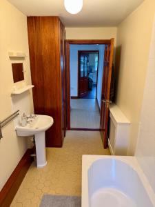 a bathroom with a white tub and a sink at Beachfront Cottage - 3 bedrooms in Clogherhead +48 photos