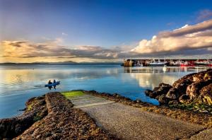 a person in a boat in a body of water at Beachfront Cottage - 3 bedrooms in Clogherhead