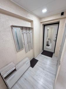 a hallway with two benches in front of a door at G2 Apartments in Rēzekne