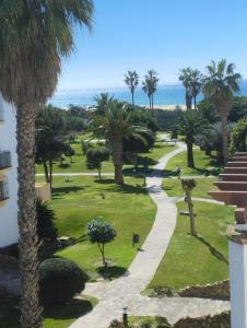a view of a park with palm trees and a path at Vitamin Sea in Zahara de los Atunes
