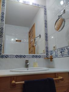 a bathroom with a sink and a mirror at Vitamin Sea in Zahara de los Atunes +11 photos
