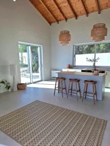 a kitchen with a counter and stools in a room at Villa Kalivista in Spartýlas