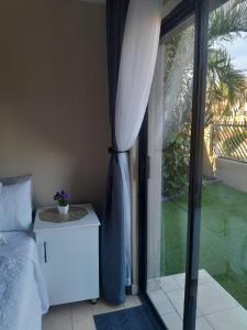 a bedroom with a bed and a sliding glass door at Guesthouse at 543 in Lebowakgomo