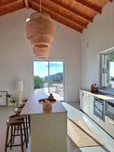 a kitchen with a table and chairs and a large window at Villa Kalivista in Spartýlas
