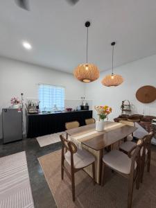 a kitchen and dining room with a wooden table and chairs at Rooma Bali Jeram in Kuala Selangor