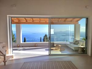a living room with a view of the ocean at Villa Kalivista in Spartýlas