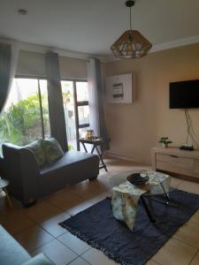 a living room with a couch and a table at Guesthouse at 543 in Lebowakgomo