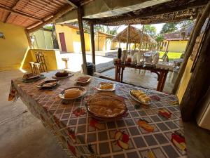 a table with plates of food on top of it at Hospedagem Portal da Terra in São João