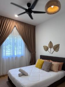 a bedroom with a bed with a ceiling fan at Rooma Bali Jeram in Kuala Selangor +23 photos