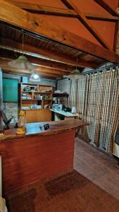a kitchen with a long counter in a room at margarita in Sauce Viejo