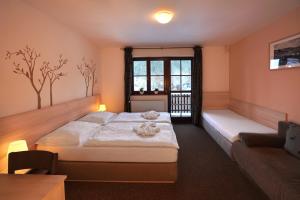 a bedroom with a large bed and a couch at Wellness hotel Sauna in Malá Morávka +68 photos