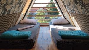 two beds in a room with a large window at DREAM house by the sea in COCOland in Epanomi