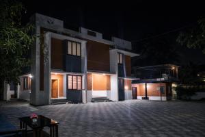 a night view of a house with a driveway at Crystal Homestay in Trivandrum