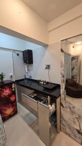 a kitchen with a counter top in a room at Elegant 1 RK Studio Balewadi in Pune