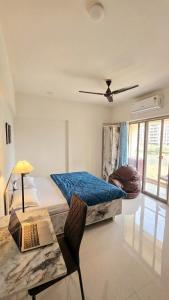 a bedroom with two beds and a table with a laptop at Elegant 1 RK Studio Balewadi in Pune