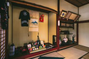 a room with a shelf with a shirt and other items at 山形イチマルニマル in Miyajuku