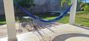a hammock on a porch with a table and chairs at Victoriano in La Rioja