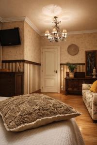 a bedroom with a bed and a chandelier at Patxiren etxea in Bermeo