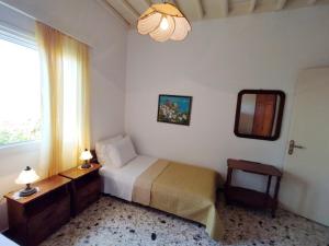 a bedroom with a bed and a window at Almond trees house in Órmos Aiyialís