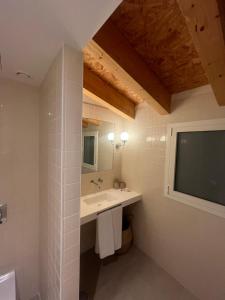 a bathroom with a sink and a flat screen tv at Hotel luna nueva in Tarragona