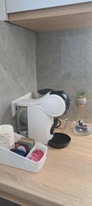 a counter top with a telephone and a sink at AirApartment in Chişinău
