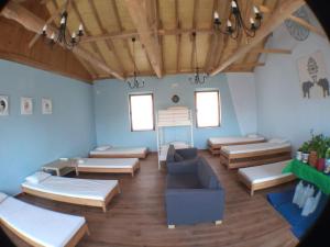 a room with several beds and a couch in it at Albergue San Bruno in Moratinos