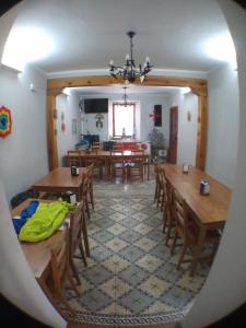 a dining room with wooden tables and chairs at Albergue San Bruno in Moratinos +26 photos